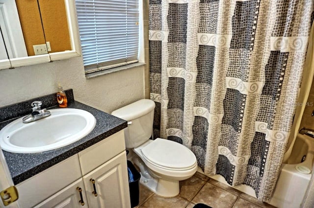 full bathroom featuring oversized vanity, toilet, tile floors, and shower / bath combo