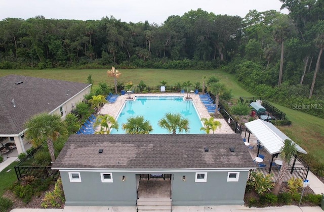 view of pool featuring a patio and a lawn