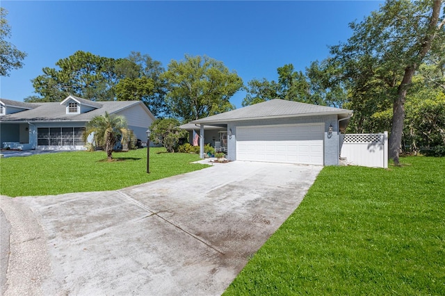 single story home featuring a front lawn and a garage