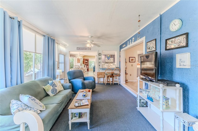 carpeted living room with ceiling fan