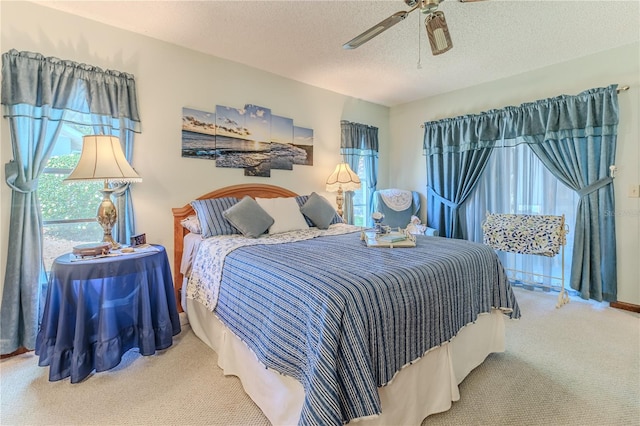 bedroom with carpet, a textured ceiling, and ceiling fan