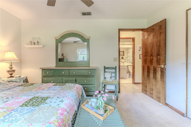 carpeted bedroom featuring a textured ceiling and ceiling fan