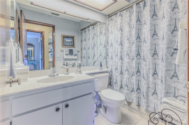 bathroom with tile patterned flooring, vanity, toilet, and a shower with shower curtain