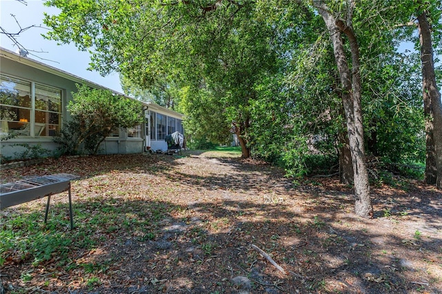 view of yard featuring a sunroom