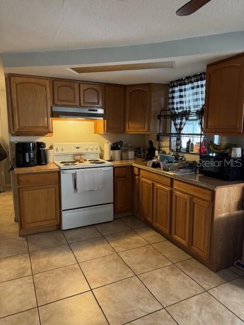 kitchen featuring a textured ceiling, electric range, light tile flooring, and ceiling fan