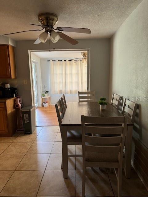 dining space featuring a textured ceiling, ceiling fan, and light hardwood / wood-style flooring