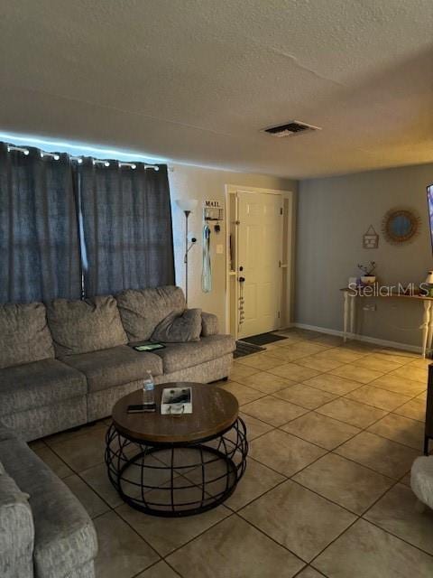 living room with tile flooring and a textured ceiling