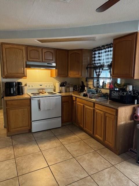 kitchen featuring a textured ceiling, white range with electric stovetop, ceiling fan, and light tile floors