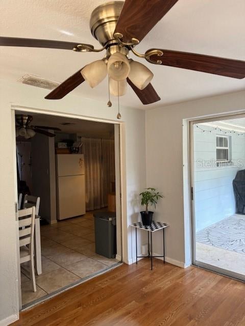 interior space featuring wood-type flooring and ceiling fan