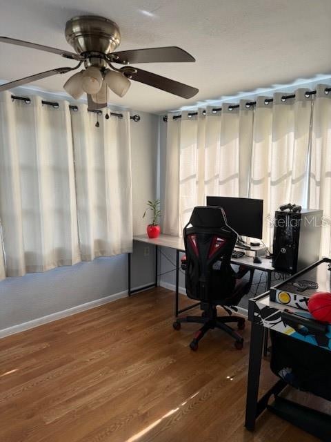 office with ceiling fan and hardwood / wood-style flooring