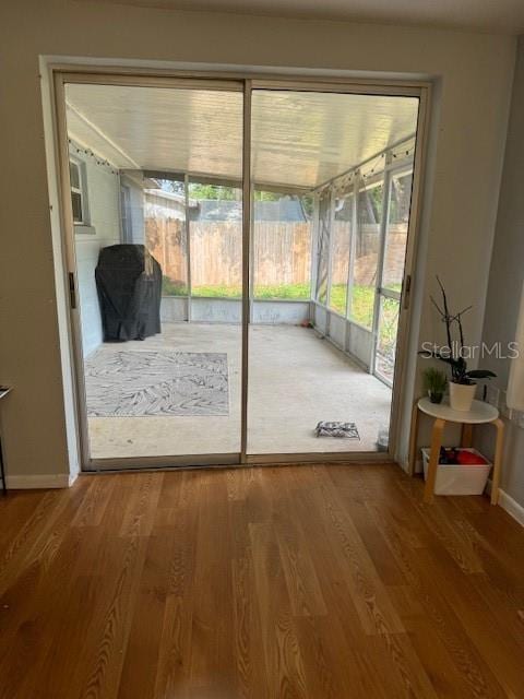 doorway with hardwood / wood-style floors and plenty of natural light