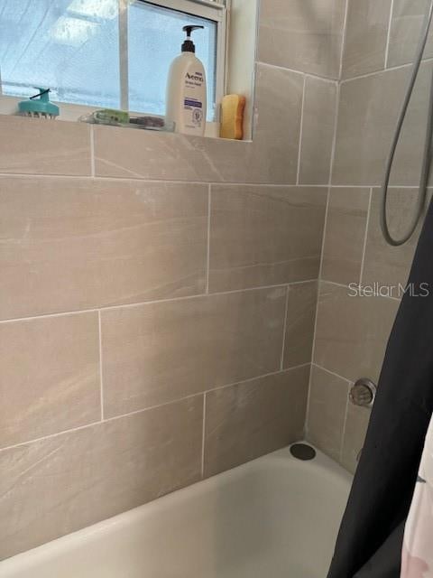 bathroom with shower / tub combo