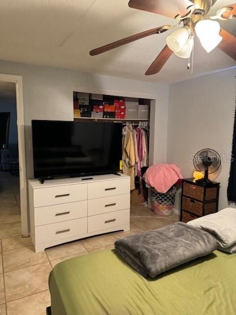 tiled bedroom featuring a closet and ceiling fan