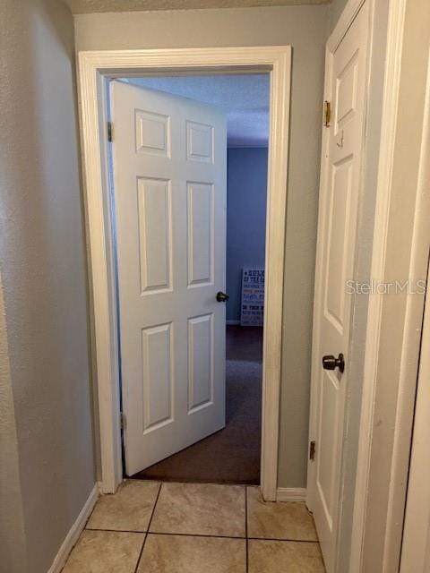 hallway featuring light tile floors