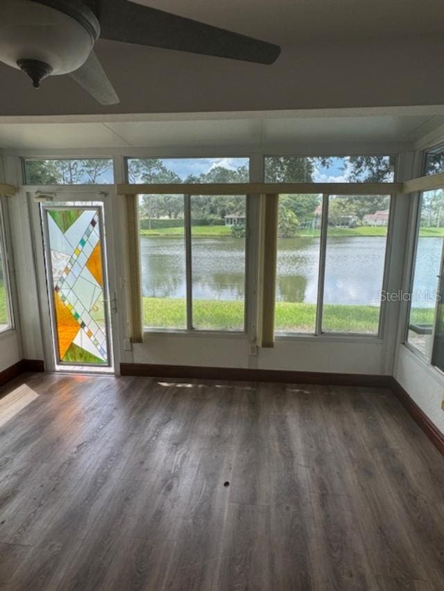 unfurnished sunroom with a water view and a healthy amount of sunlight