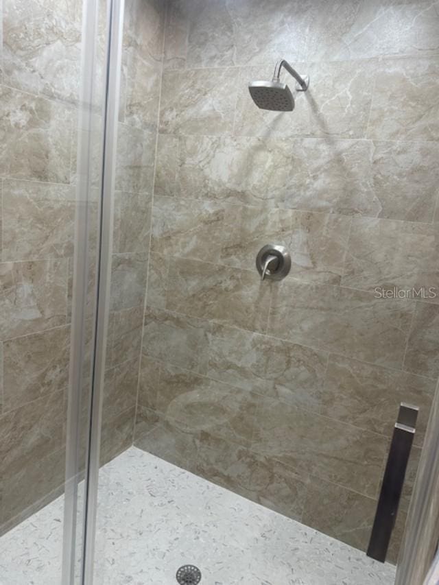 bathroom with a shower with shower door