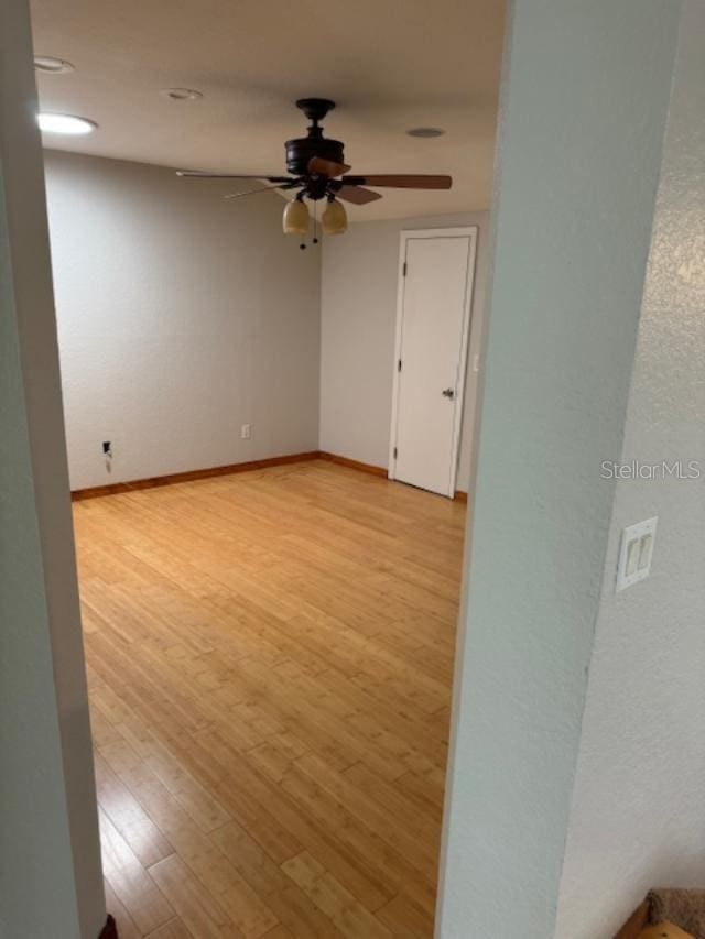 empty room featuring light hardwood / wood-style flooring and ceiling fan