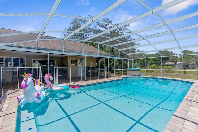 view of pool featuring a patio, ceiling fan, and glass enclosure