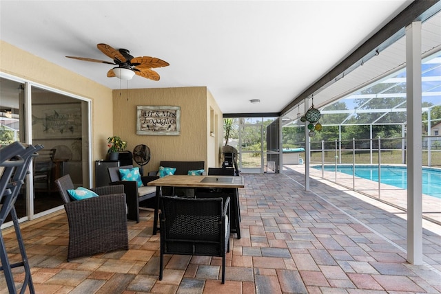 view of patio with glass enclosure and ceiling fan