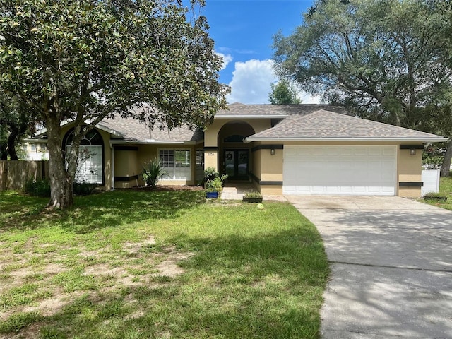 view of front of home featuring a garage and a front lawn