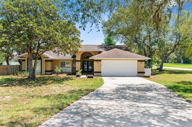 view of front facade with a garage and a front lawn