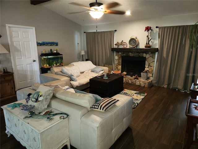 living room with hardwood / wood-style floors, a stone fireplace, lofted ceiling with beams, and ceiling fan