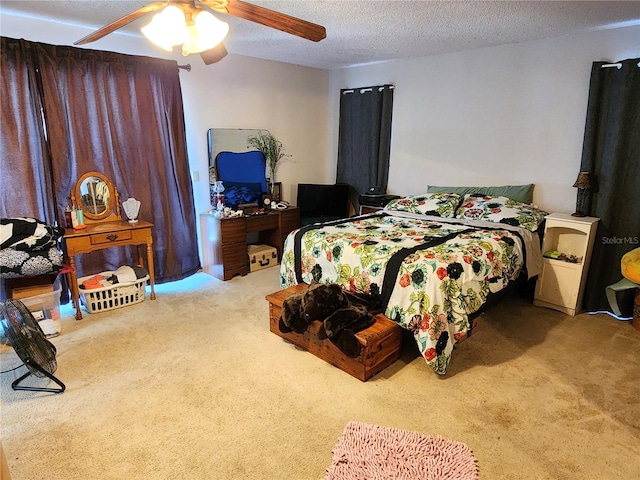 carpeted bedroom featuring ceiling fan and a textured ceiling