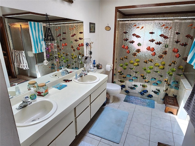 bathroom featuring dual bowl vanity, tile flooring, and toilet