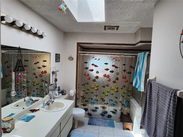 full bathroom featuring a skylight, vanity with extensive cabinet space, toilet, tile flooring, and shower / tub combo with curtain