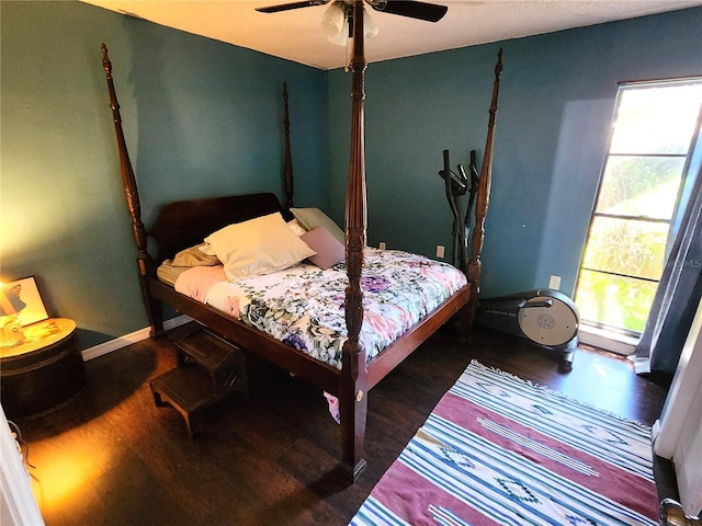 bedroom with dark hardwood / wood-style floors and ceiling fan