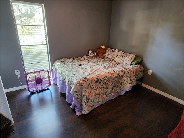 bedroom with dark hardwood / wood-style flooring