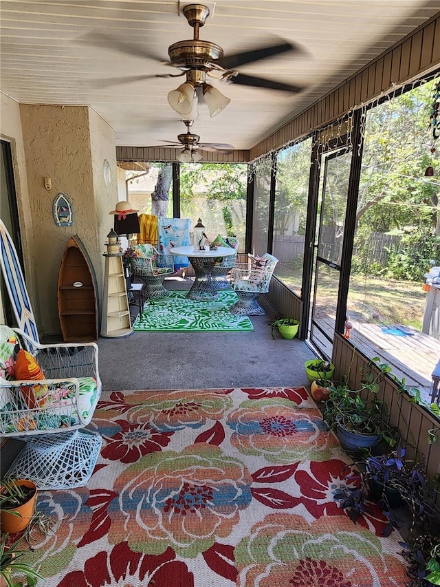 sunroom / solarium with plenty of natural light and ceiling fan