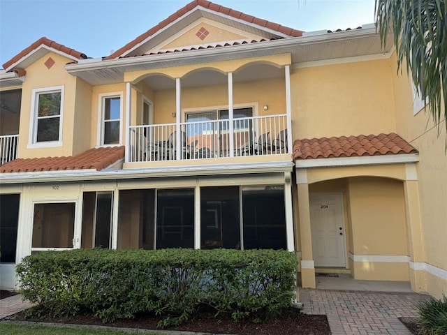 rear view of house featuring a balcony