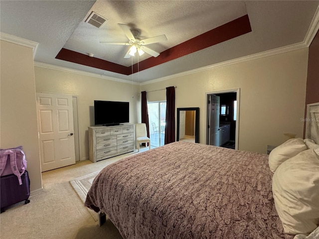 bedroom with a raised ceiling, ceiling fan, light carpet, and a textured ceiling