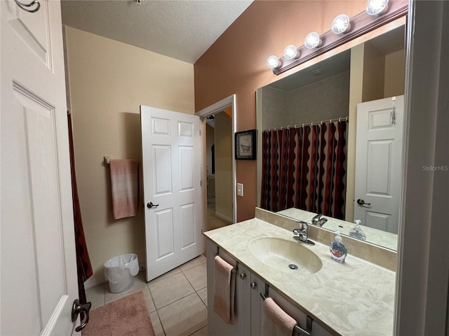 bathroom featuring a shower with shower curtain, a textured ceiling, vanity, and tile patterned floors