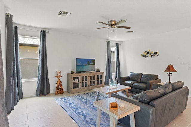 tiled living room featuring a healthy amount of sunlight and ceiling fan