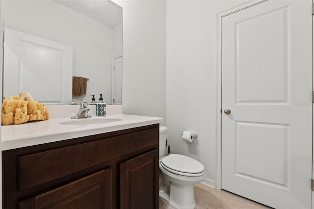 bathroom with tile flooring, toilet, and vanity