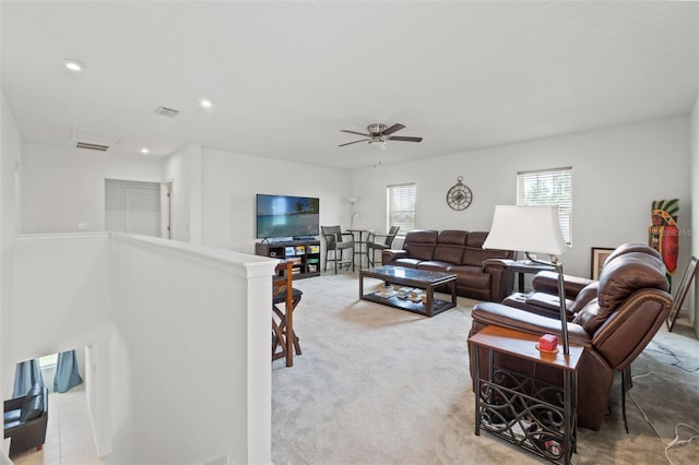 carpeted living room featuring ceiling fan