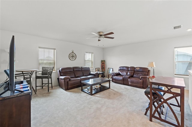 carpeted living room featuring plenty of natural light and ceiling fan