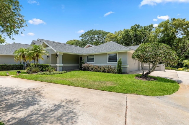 single story home with a garage and a front lawn