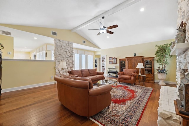 living room with ceiling fan, wood-type flooring, high vaulted ceiling, beamed ceiling, and a fireplace