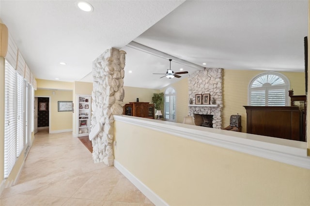 hallway featuring lofted ceiling with beams and a textured ceiling