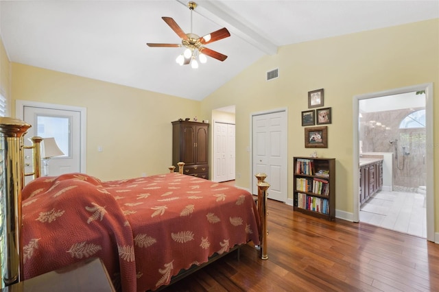 bedroom with lofted ceiling with beams, ensuite bathroom, ceiling fan, and dark wood-type flooring