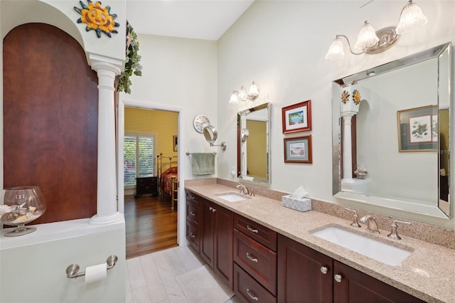 bathroom featuring vanity, wood-type flooring, and ornate columns