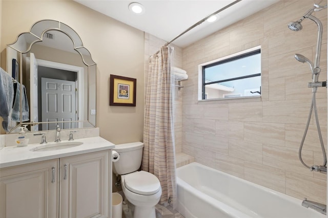 full bathroom featuring vanity, shower / bath combination with curtain, and toilet