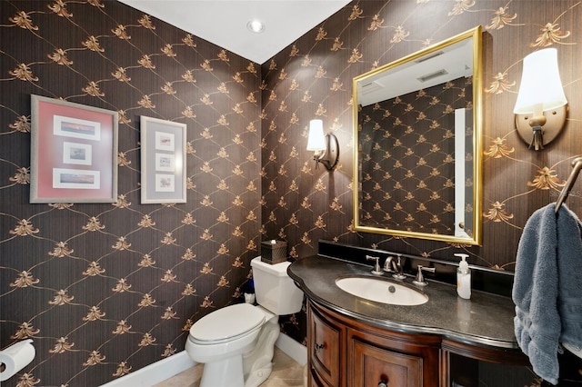 bathroom featuring tile patterned flooring, vanity, and toilet