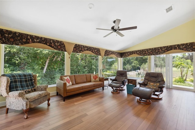 sunroom / solarium with ceiling fan and vaulted ceiling