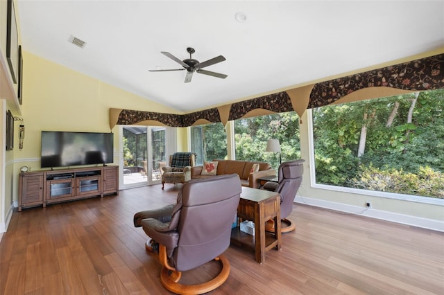 living room featuring ceiling fan, wood-type flooring, and vaulted ceiling