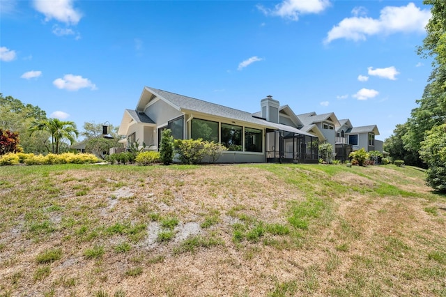 rear view of property featuring a lawn