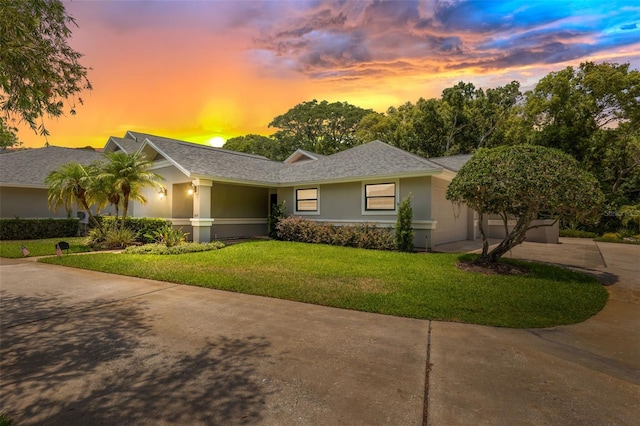 single story home featuring a lawn